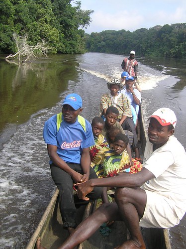 On our way down the Lomami river to Ngombe village, DRCongo, with the chief of Obenge in the cowboy hat