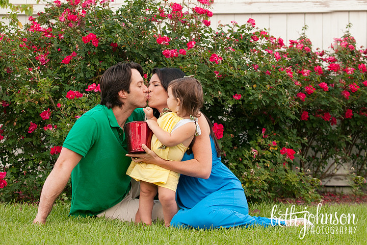 family of three with mama and daddy kissing