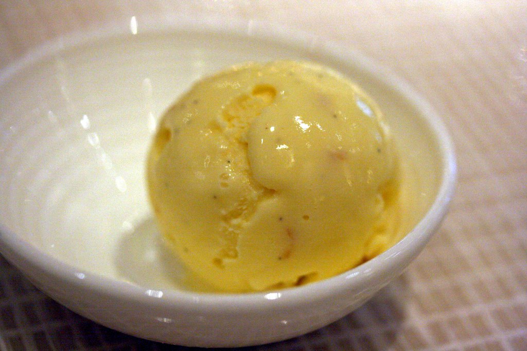 A sphere of Green cardamom caramel, sea salt and almond ice cream
