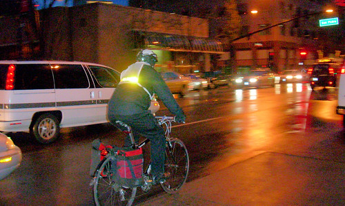 Cyclist riding with reflective safety vest