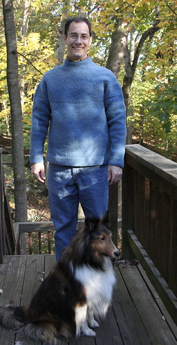 Portrait of a man, a dog, and a finished sweater