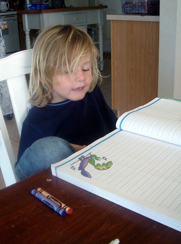k doing schoolwork, hair in his face