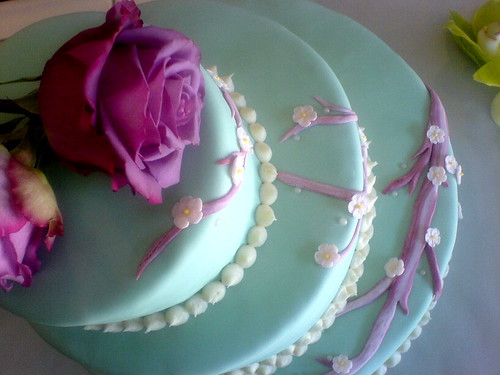 teal fondant with pink cherry blossom flowers The cake was embellished