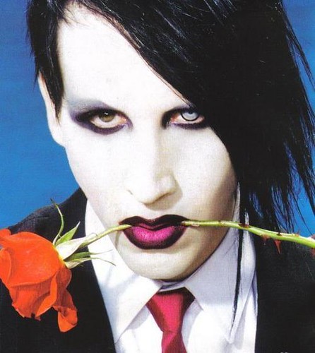 Marilyn Manson holing a rose in mouth