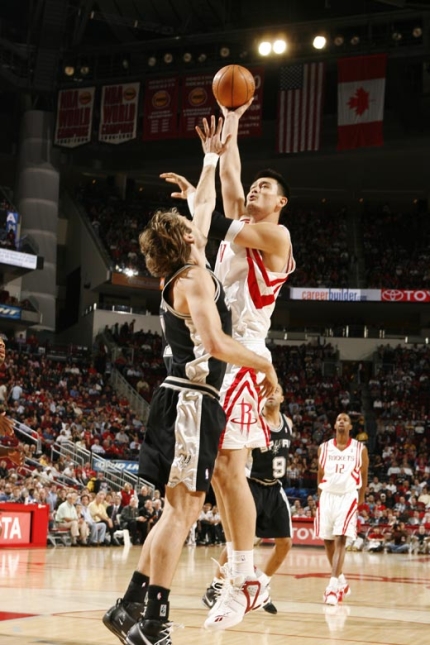 Yao Ming shoots a jump hook in the lane over San Antonio's Fabricio Oberto in a big win Tuesday night against the Spurs.  Yao scored 28 points, grabbed 13 boards, dished 6 assists and blocked 3 shots.