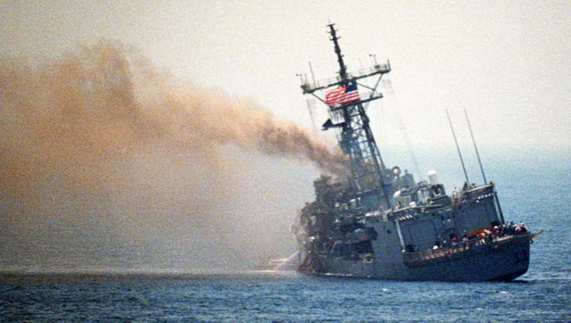 U.S.S. Stark listing after being struck by two Exocet missiles fired by Mirage F-1 jet fighter of Saddam Hussein’s (1987-05-17; Wikipedia)