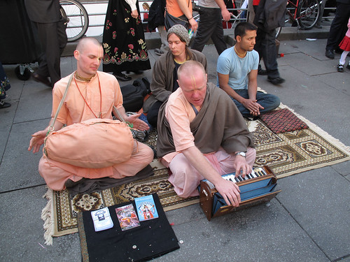 Hare Krishna worked hard to be heard over the sound of the indians.