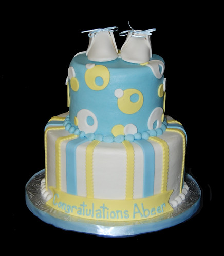 Blue and Yellow 2 tier baby shower cake with baby booties