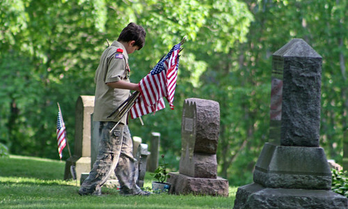 Placing flags at the graves of veterans