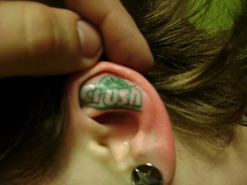Tattoo On Ear. lettering tattoo in ear