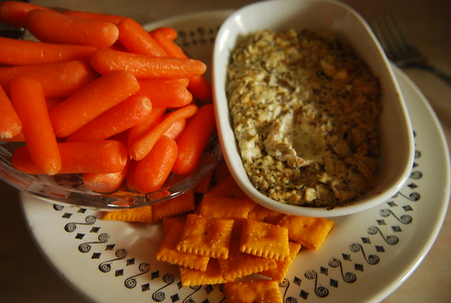 Hot artichoke dip with carrots and crackers