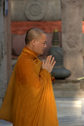 A Buddhist Monk Prays At Mahabodhi Temple