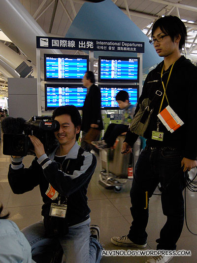 Camera crew going around interviewing the couples in the airport