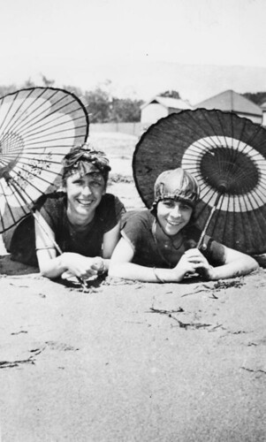 Beach girls posing under their umbrellas, Brisbane, ca. 1925 by State Library of Queensland, Australia