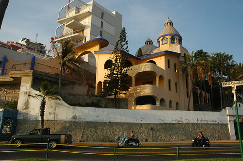 Truck and motorcycles on the road, modern castle at Paseo Claussen & Gral Angel Flores, South Mazatlan, Sinaloa, Mexico by Wonderlane