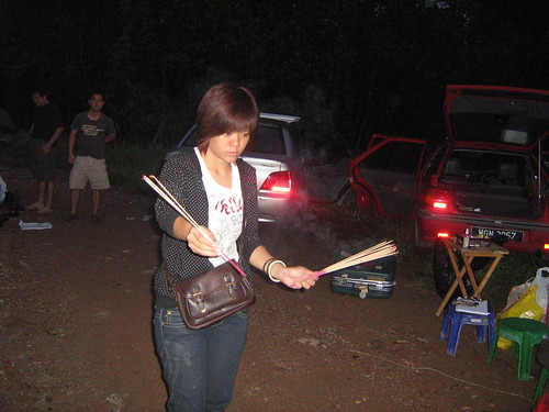Assistant director Khai Sim with joss sticks