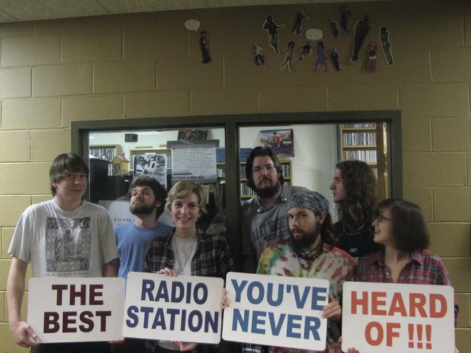 WMWC staff pose front of the station in the Woodard Campus Center. From left: Will Loring, Andrew Allingham, Sarah Kelly, Jeremy Lay, Joe Calpin, Connor Whitaker and Emily Harris.