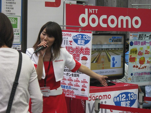 A Bic Camera employee demoing Wii Sports outside the store.