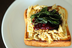 Leftover Roast Chicken Shredded Sitting on Thick Toast and Grilled Cheese and Topped with Lingonberry Jam and Fried Sage Leaves