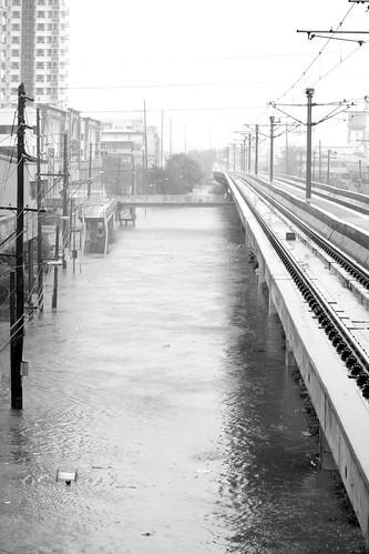 Shot from V. Mapa station, street flooded at depths between 4-5 ft., by rembcc (n.b.: yes, that is a man trying to keep afloat)