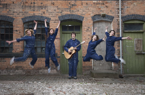Five people from Tin Box Theatre Company jumping in the air excitedly