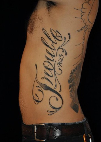 script lettering on a rib cage Photo by Justin Dion