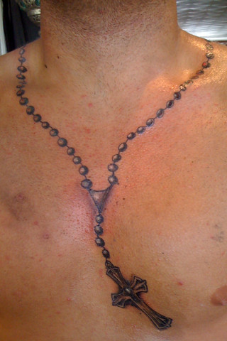 rosary tattoo on forearm
