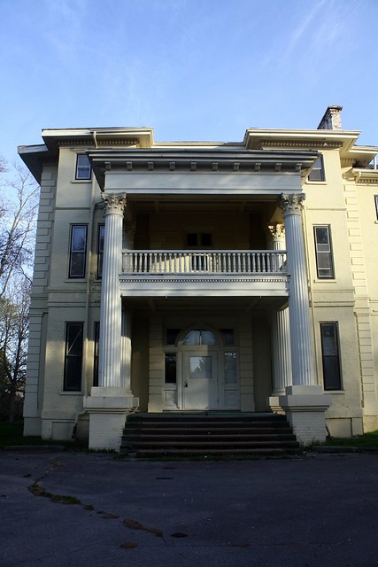 Beau-arts Corinthian portico with balcony and one-storey Corinthian porch added in 1900