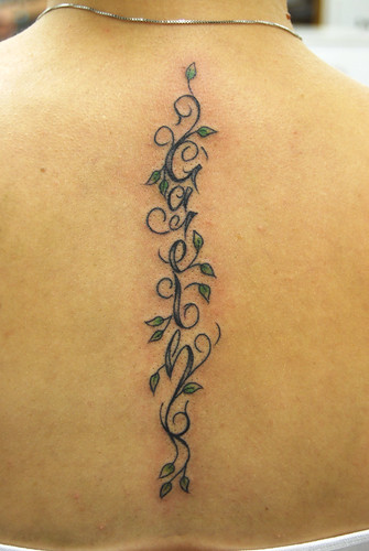 flower and vine tattoos. vine and leaf lettering tattoo
