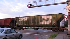 A former Burlington Northern RR covered hopper in transit crosses Archer Avenue. Chicago Illinois. August 2009.