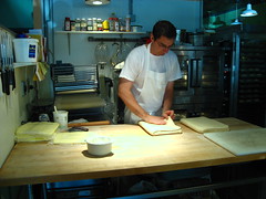 The pastry chef at work. Thats a stack of butter slabs on the left there.