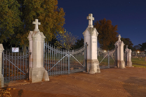 Saints Peter and Paul Roman Catholic Cemetery, in Saint Louis, Missouri, USA - view of cemetary gates at night with stars