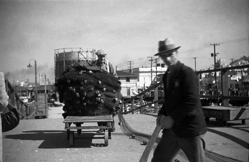 Pushing Pile of Fishing Nets 1941