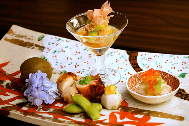 Appetiser platter - kazunoko (in glass), aoume or Japanese plum, anago (sea eel) sushi, tako, zuiki (stem of taro) with ikura (salmon roe), yam with miso, edamame beans