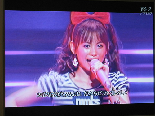 This idol was on tv giving a concert. I think she sings a lot of anime songs, because she sang the theme songs from Neon Genesis Evangelion, The Melancholy of Haruhi Suzumiya, Pokemon, Sailor Moon, and many others.