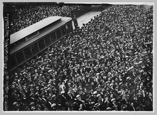 Huge crowd of baseball fans watching baseball scoreboard during World Series game in New York City