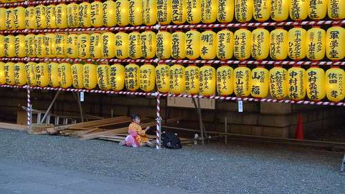 Little girl eating alone during Mitaka Matsuri