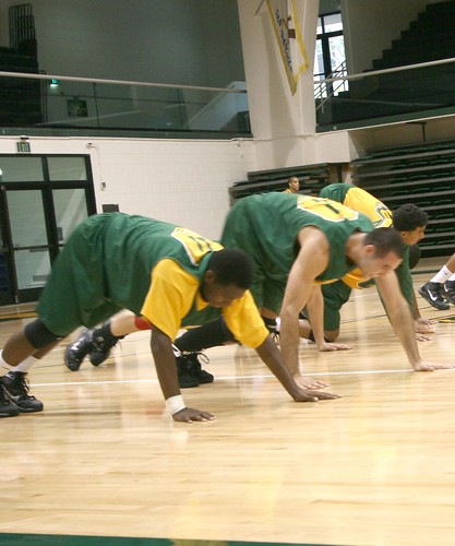 The USF Dons stretch to warm up at the beginning of practice.  Photo by Matt Steinbach/Foghorn