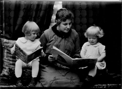 Student reading to two little girls. Photographed for 1920 home economics catalog by Troy.