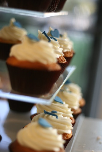 Blue and white wedding cupcakes Alternating blue hearts and blue initials 