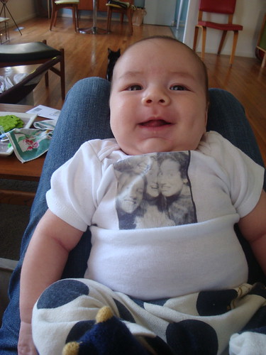desi wearing his onsie from auntie erin, featuring a screen of one of our famous photobooth sessions from high school