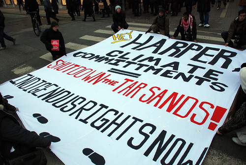 Protesters block street with massive tar sands banner