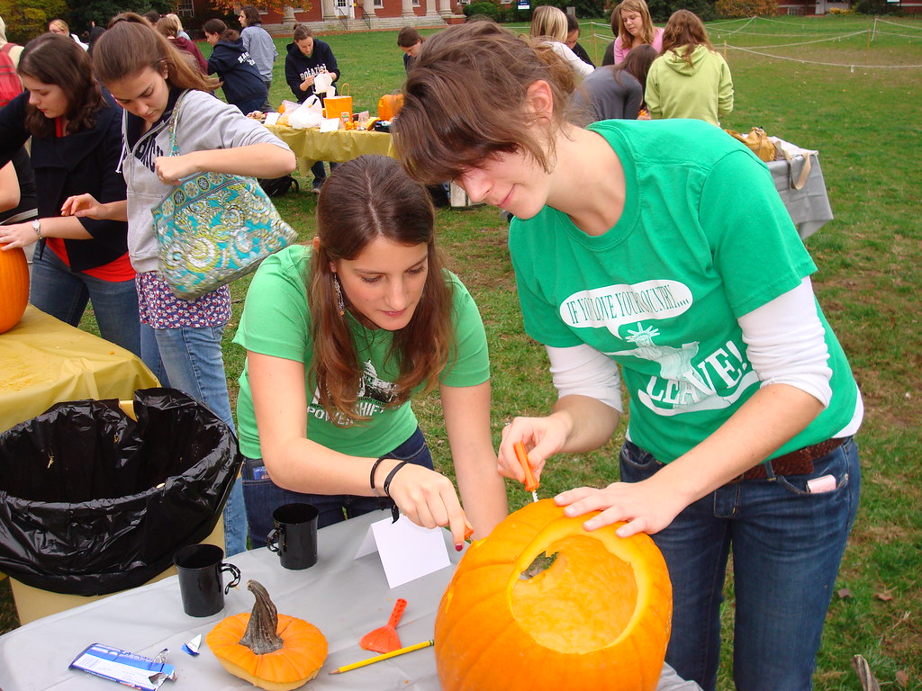 From left: exchange students Manon Vernier and Julia Preuß work on their pumpkin.   