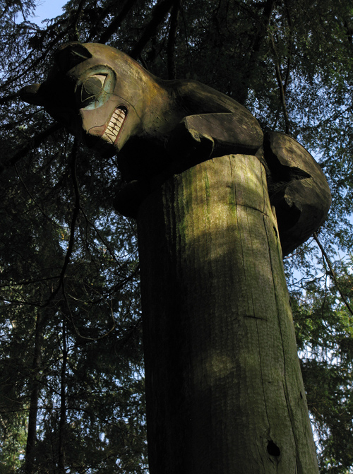 a bear figure atop a memorial totem pole in Kasaan Totem Park, Kasaan, Alaska