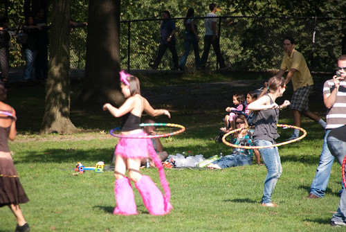 girl in a cat costume hula hooping in Central Park
