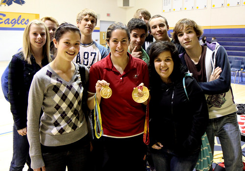 Katie Weatherston displays her Olympic Gold Medal and her World Championship Gold Medal with DHS students.