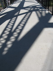 Shadows on the old railroad bridge across the ...