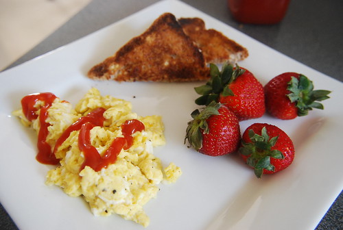 Scrambled eggs, toast, strawberries