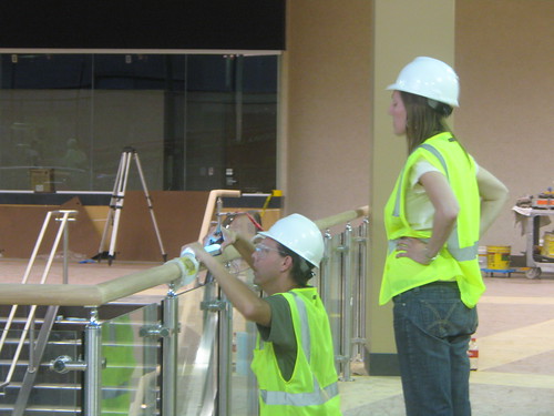 Camille Utterback and Alan H. Davidson installing touch sensitive handrail for interactive light work.