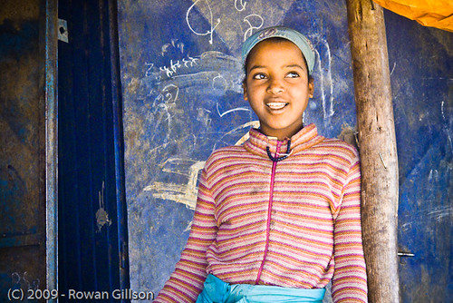 A young girl pauses from selling produce for a quick portrait in Addis Ababa, Ethiopia.